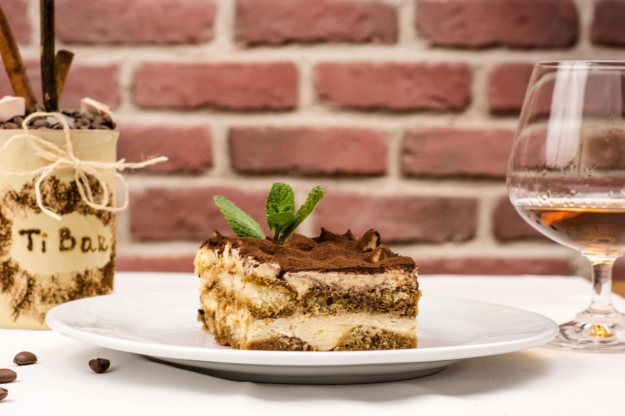 Tiramisù con crema al mascarpone, strati di savoiardi e cacao spolverato in cima.